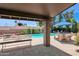 Covered patio with outdoor seating and lush landscaping overlooking the backyard pool at 5045 E Redfield Rd, Scottsdale, AZ 85254