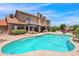 Backyard with a large pool, a patio with an umbrella, and desert landscaping at 5045 E Redfield Rd, Scottsdale, AZ 85254