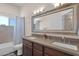 Bathroom featuring a double vanity, large mirror, and a separate shower and toilet area at 5045 E Redfield Rd, Scottsdale, AZ 85254