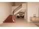 Grand foyer entrance with staircase, tiled floor, and elegant lighting offering a warm welcome to guests at 5045 E Redfield Rd, Scottsdale, AZ 85254