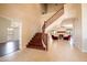 Inviting foyer featuring a staircase, tile floors, and an open view into the living room with a fireplace at 5045 E Redfield Rd, Scottsdale, AZ 85254