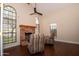 Open living room with vaulted ceiling, ceiling fan, hardwood floors, and a brick fireplace at 5045 E Redfield Rd, Scottsdale, AZ 85254