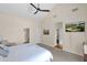 Bright main bedroom featuring vaulted ceilings, television, walk-in closet and en-suite bathroom at 5045 E Redfield Rd, Scottsdale, AZ 85254