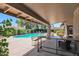 Covered patio overlooking a pool with lounge seating, dining area, and lush landscaping at 5045 E Redfield Rd, Scottsdale, AZ 85254