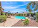 Backyard with a turquoise pool, a patio area with an umbrella, and desert landscaping at 5045 E Redfield Rd, Scottsdale, AZ 85254