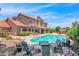 Inviting backyard oasis featuring a sparkling pool, lush landscaping, and comfortable seating areas at 5045 E Redfield Rd, Scottsdale, AZ 85254