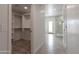 Well-organized walk-in closet with custom shelving leading to ensuite bathroom with glass shower at 5045 E Redfield Rd, Scottsdale, AZ 85254