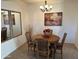 Charming dining area with a round table, decorative mirrors, and a lovely chandelier for intimate meals at 5518 E Lindstrom Ln # 3010, Mesa, AZ 85215