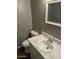 Bathroom featuring sleek vanity with sink and toilet at 7126 N 19Th Ave # 103, Phoenix, AZ 85021