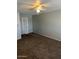 Bedroom with carpet flooring and light colored walls with a ceiling fan and light at 7126 N 19Th Ave # 103, Phoenix, AZ 85021