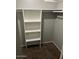 View of the interior of the carpeted walk-in closet with several shelves at 7126 N 19Th Ave # 103, Phoenix, AZ 85021