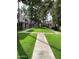 Community lawn with mature trees and sidewalks between units at 7126 N 19Th Ave # 103, Phoenix, AZ 85021