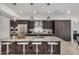 Modern kitchen featuring dark wood cabinets, granite counters, and stainless steel appliances at 7180 E Kierland Blvd # 312, Scottsdale, AZ 85254