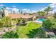 Aerial backyard view with green grass, mature landscaping, and a private pool at 725 E Country Gables Dr, Phoenix, AZ 85022