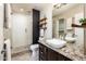 Modern bathroom featuring a walk-in shower, stylish vanity, and decorative wood shelves for storage at 725 E Country Gables Dr, Phoenix, AZ 85022