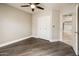 Neutral-toned bedroom featuring tile floors, a ceiling fan, a closet, and access to another room at 725 E Country Gables Dr, Phoenix, AZ 85022