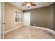 Bedroom with tiled floor, shuttered window and closet with a neutral color scheme at 725 E Country Gables Dr, Phoenix, AZ 85022