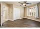 Neutral-toned bedroom with tiled floors, a ceiling fan, a closet, and large window, providing ample natural light at 725 E Country Gables Dr, Phoenix, AZ 85022