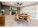 Comfortable dining area with a modern ceiling fan, and stylish stone fireplace at 725 E Country Gables Dr, Phoenix, AZ 85022