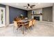 Cozy dining area featuring a brick fireplace and a modern ceiling fan at 725 E Country Gables Dr, Phoenix, AZ 85022