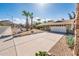 Single-story home featuring desert landscaping, an extended driveway, and a two-car garage at 725 E Country Gables Dr, Phoenix, AZ 85022