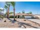 Single-story home with desert landscaping, a two-car garage, and an inviting front entrance at 725 E Country Gables Dr, Phoenix, AZ 85022