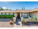 Charming single-story home featuring a manicured front yard and a welcoming front entrance at 725 E Country Gables Dr, Phoenix, AZ 85022