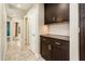 Hallway with view to the back of the home and decorative cabinets at 725 E Country Gables Dr, Phoenix, AZ 85022