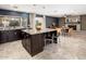 Open-concept kitchen with a large island flowing into the dining area with a fireplace at 725 E Country Gables Dr, Phoenix, AZ 85022