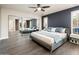 Spacious main bedroom featuring mirrored closet doors, a modern bed frame, and ample natural light at 725 E Country Gables Dr, Phoenix, AZ 85022