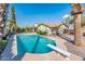 Backyard pool with diving board and desert landscaping at 725 E Country Gables Dr, Phoenix, AZ 85022