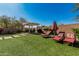 Lush backyard featuring artificial turf, a covered pergola, and lounge chairs for relaxation at 7252 N 90Th Ln, Glendale, AZ 85305