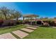 Beautiful backyard with a pergola, patio furniture, and artificial turf perfect for outdoor living at 7252 N 90Th Ln, Glendale, AZ 85305