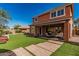 Expansive backyard with a covered patio and a lush green lawn perfect for outdoor activities at 7252 N 90Th Ln, Glendale, AZ 85305