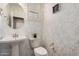 Chic powder room with stylish wallpaper, a pedestal sink, and modern fixtures offering a touch of elegance at 7252 N 90Th Ln, Glendale, AZ 85305