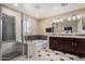 Bathroom features a walk-in shower, drop-in tub, double vanity sinks, tile floors, and plenty of natural light at 7252 N 90Th Ln, Glendale, AZ 85305