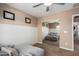 Bedroom featuring wainscotting, a ceiling fan, comfortable seating, and a sliding mirror door at 7252 N 90Th Ln, Glendale, AZ 85305