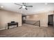 Open bonus room with a piano, neutral paint, ceiling fan, and view of the staircase at 7252 N 90Th Ln, Glendale, AZ 85305