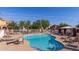 Sparkling community pool with lounge chairs and a covered picnic area for relaxing at 7252 N 90Th Ln, Glendale, AZ 85305