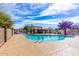 Community pool with clear blue water and picnic shelter, a wonderful community amenity at 7252 N 90Th Ln, Glendale, AZ 85305