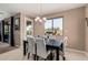 Elegant dining room featuring a stylish chandelier, comfortable seating, and a view of the outdoor area at 7252 N 90Th Ln, Glendale, AZ 85305