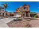 Charming two-story stucco home with desert landscaping, a wide driveway, and a welcoming entrance at 7252 N 90Th Ln, Glendale, AZ 85305