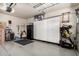 Organized garage area with ample storage cabinets and durable epoxy flooring for easy maintenance at 7252 N 90Th Ln, Glendale, AZ 85305