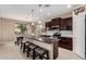 Gourmet kitchen featuring granite countertops, a center island with seating, and a seamless flow to the dining area at 7252 N 90Th Ln, Glendale, AZ 85305