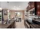 Modern kitchen boasting stainless steel appliances, a breakfast bar, and an open layout to the dining space at 7252 N 90Th Ln, Glendale, AZ 85305