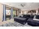 Bright living room with sliding glass doors leading to the patio and an open view to the kitchen at 7252 N 90Th Ln, Glendale, AZ 85305