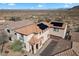 Aerial view of a home with a solar-paneled roof in a desert community setting at 7428 W Montgomery Rd, Peoria, AZ 85383