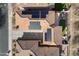 Bird's eye view of roof with solar panels and paved driveway amid a desert community at 7428 W Montgomery Rd, Peoria, AZ 85383