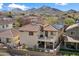 Home with backyard patio viewed from above, nestled in a desert community with mountain views at 7428 W Montgomery Rd, Peoria, AZ 85383