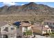 Home's solar panels stand out against the backdrop of distant mountains in a desert community at 7428 W Montgomery Rd, Peoria, AZ 85383